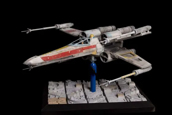 Studio-scale X-wing model Red 7 on a display base, front three-quarter view