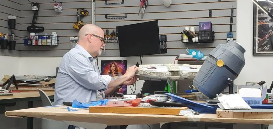 The maker at the workbench, detailing a studio model
