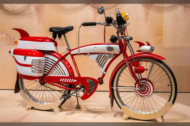 The screen-used Pee-wee Herman bike after restoration, displayed on a stand